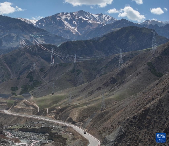 4月23日，在國網(wǎng)新源新疆阜康抽水蓄能電站，工作人員乘坐大巴車上山作業(yè)（無人機照片）。新華社記者 陳朔 攝